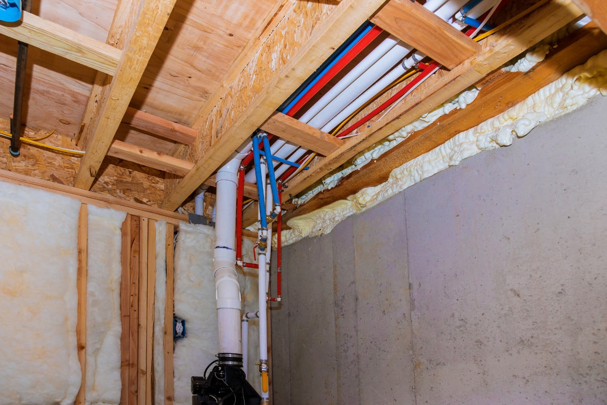 Exposed frozen PVC pipe in a basement.